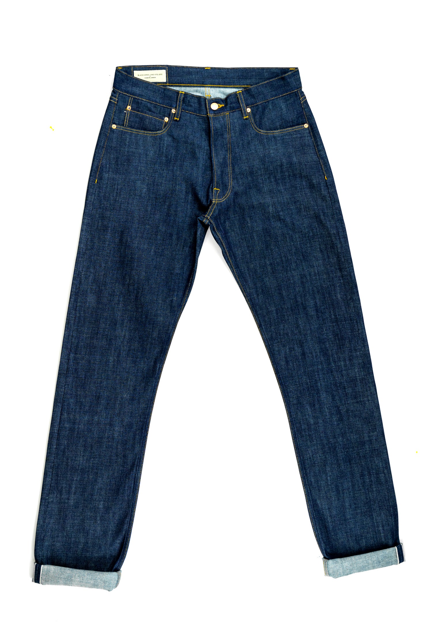 A pair of raw selvedge jeans shown flat from the front.